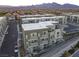 Newly constructed townhomes with attached garages, balconies, set against a backdrop of mountains at 1181 Blossom Point St, Las Vegas, NV 89135