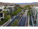 A landscaped street scene showing modern apartments, palm trees, and well-maintained sidewalks in a residential neighborhood at 1181 Blossom Point St, Las Vegas, NV 89135