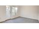 Airy bedroom with plush carpet, large window, and a glass door to the exterior at 1187 Blossom Point St # 36, Las Vegas, NV 89135