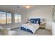 Bright bedroom with large windows, plush blue accents and comfortable seating at 1187 Blossom Point St # 36, Las Vegas, NV 89135