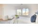 Bright bedroom with large windows, plush blue accents and comfortable seating at 1187 Blossom Point St # 36, Las Vegas, NV 89135