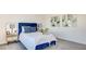 Comfortable bedroom with neutral colors, and a plush blue headboard and pillows at 1187 Blossom Point St # 36, Las Vegas, NV 89135