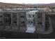 A modern gray townhouse complex with individual garages at 1187 Blossom Point St # 36, Las Vegas, NV 89135