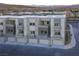 Modern townhome exterior with multiple balconies, gray stone accents, and a two-car garage at 1187 Blossom Point St # 36, Las Vegas, NV 89135