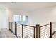 Upstairs hallway featuring wood-style flooring and modern horizontal railing system at 1187 Blossom Point St # 36, Las Vegas, NV 89135