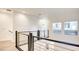 Upstairs hallway featuring wood-style flooring and modern horizontal railing system at 1187 Blossom Point St # 36, Las Vegas, NV 89135