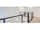 Upstairs hallway featuring wood-style flooring and modern horizontal railing system at 1187 Blossom Point St # 36, Las Vegas, NV 89135