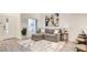 Inviting living room with a cozy sectional, modern art, and natural light from the window at 1187 Blossom Point St # 36, Las Vegas, NV 89135