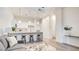 Bright open floor plan with modern lighting, kitchen island, and stylish gray sofa at 1187 Blossom Point St # 36, Las Vegas, NV 89135