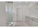 Bright bathroom featuring a glass enclosed shower, double vanity sinks, and contemporary design at 12123 Glentana View St, Las Vegas, NV 89138