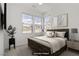 Cozy bedroom is virtually staged and features three windows and neutral decor at 12123 Glentana View St, Las Vegas, NV 89138