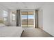 Bright bedroom with a large sliding glass door, neutral decor and expansive views at 12123 Glentana View St, Las Vegas, NV 89138