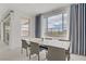 Bright dining room with natural light, modern table, chairs and views of backyard at 12123 Glentana View St, Las Vegas, NV 89138