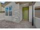 Charming entrance with stacked stone and an eye-catching green door, creating a welcoming curb appeal at 12123 Glentana View St, Las Vegas, NV 89138