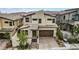 Stylish two-story home featuring a stone accent wall and a brick driveway, complemented by desert landscaping at 12123 Glentana View St, Las Vegas, NV 89138