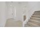 A bright foyer with tile flooring, a staircase, and a view of the front door at 12123 Glentana View St, Las Vegas, NV 89138