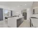 Modern kitchen featuring an island, stainless steel appliances, and an adjacent dining area at 12123 Glentana View St, Las Vegas, NV 89138