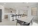 Open kitchen features large island with a sink, bar stool seating, dining area and appliances at 12123 Glentana View St, Las Vegas, NV 89138