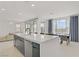 Open kitchen features large island with a sink, stainless appliances and an adjacent dining area at 12123 Glentana View St, Las Vegas, NV 89138