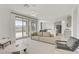 Open-concept living room with tile flooring, modern furniture, and a seamless flow into the kitchen at 12123 Glentana View St, Las Vegas, NV 89138