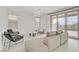 Bright living room with neutral-toned furniture, tile flooring, and sliding glass doors leading to an outdoor area at 12123 Glentana View St, Las Vegas, NV 89138