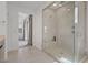 Spacious walk-in shower featuring glass enclosure, a rainfall showerhead, and built-in seat at 12123 Glentana View St, Las Vegas, NV 89138