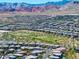 A neighborhood community of homes and green spaces against a backdrop of colorful desert mountains in the distance at 12311 Middle Creek St, Las Vegas, NV 89138
