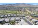 An aerial view showing houses and street and landscaping in the community against a backdrop of desert mountains at 12311 Middle Creek St, Las Vegas, NV 89138