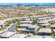 An aerial view shows a neighborhood street with houses and desert landscaping against the backdrop of the Las Vegas skyline at 12311 Middle Creek St, Las Vegas, NV 89138
