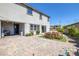 Spacious backyard featuring a paver patio, landscaping, and a view of the home's exterior at 12311 Middle Creek St, Las Vegas, NV 89138