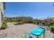 Spacious backyard featuring a paver patio, landscaping, and lounge seating at 12311 Middle Creek St, Las Vegas, NV 89138