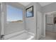Bathroom view featuring soaking tub and window with views of distant mountain landscape and walk-in closet at 12311 Middle Creek St, Las Vegas, NV 89138