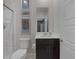 Contemporary bathroom features a vanity with dark wood cabinets, a framed mirror, and a shower with white subway tile at 12311 Middle Creek St, Las Vegas, NV 89138
