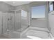 Bright bathroom featuring a modern glass shower, soaking tub, and mountain view window at 12311 Middle Creek St, Las Vegas, NV 89138