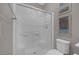 Clean, modern bathroom with a white tiled shower and framed prints displayed on the gray walls at 12311 Middle Creek St, Las Vegas, NV 89138