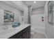 Modern bathroom featuring a double vanity with dark cabinets and quartz countertops at 12311 Middle Creek St, Las Vegas, NV 89138
