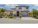 Beautiful two-story home featuring a neutral palette, manicured landscaping, and a paved driveway at 12311 Middle Creek St, Las Vegas, NV 89138