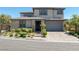 Charming two-story home with stone accents, well-manicured landscaping, and a paved driveway at 12311 Middle Creek St, Las Vegas, NV 89138