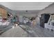 Spacious, well-lit garage with ample storage and gray wood-look flooring, perfect for organization and projects at 12311 Middle Creek St, Las Vegas, NV 89138