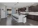 Open kitchen featuring dark cabinetry, a large center island, and access to the backyard at 12311 Middle Creek St, Las Vegas, NV 89138