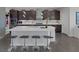 Spacious kitchen featuring a large center island with bar seating and stylish dark cabinetry at 12311 Middle Creek St, Las Vegas, NV 89138