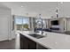 The large kitchen island creates space to look out into the dining and living area at 12311 Middle Creek St, Las Vegas, NV 89138