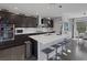 Stylish kitchen boasts a large island with seating, stainless steel appliances, and dark cabinets at 12311 Middle Creek St, Las Vegas, NV 89138