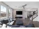 A living room with a gray accent wall, modern ceiling fan, and cozy seating provides a relaxing retreat at 12311 Middle Creek St, Las Vegas, NV 89138