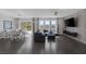 Bright, open-concept living and dining area with hardwood floors and large windows at 12311 Middle Creek St, Las Vegas, NV 89138