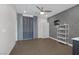 Spacious living space with decorative gray accent wall, modern ceiling fan, and bright window with curtains at 12311 Middle Creek St, Las Vegas, NV 89138