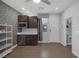 Modern living space featuring stylish gray accent wall, wood floors, kitchenette, and bright natural light at 12311 Middle Creek St, Las Vegas, NV 89138