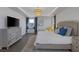 Spacious main bedroom featuring stylish furnishings, tray ceilings, recessed lights, and ample natural light at 12311 Middle Creek St, Las Vegas, NV 89138