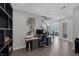Open office with built-in shelves and an ergonomic workstation, leading to the main living area at 12311 Middle Creek St, Las Vegas, NV 89138