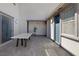 Outdoor patio features a dining table, stucco walls, and dark trim accents at 12311 Middle Creek St, Las Vegas, NV 89138